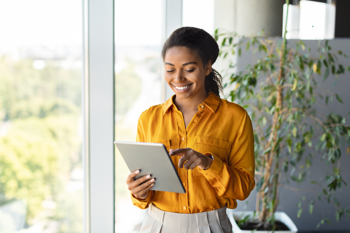 A woman reading a tablet device